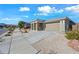 Single-story home with stone accents and a two-car garage at 18956 W Laurel Ln, Surprise, AZ 85388