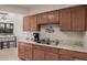 Clean and functional kitchen with double sink and wood cabinets at 19685 N Star Ridge Dr, Sun City West, AZ 85375