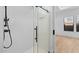 Modern shower with clear glass enclosure and white subway tile, complemented by bright lighting at 20316 W Turney Ave, Buckeye, AZ 85396
