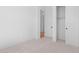 Carpeted bedroom with closet and adjoining door to another room at 20316 W Turney Ave, Buckeye, AZ 85396