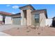 Stylish single-story home boasts stone accents, neutral colors, low-maintenance yard, and a two-car garage at 20316 W Turney Ave, Buckeye, AZ 85396