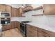 Modern kitchen with gas range, tile backsplash, stainless steel appliances and ample cabinet space at 20316 W Turney Ave, Buckeye, AZ 85396