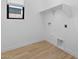 Laundry area with tile floors, window, utility connections, and overhead shelf at 20316 W Turney Ave, Buckeye, AZ 85396