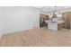 Open-concept living room and kitchen boasts modern appliances, wood floors, and bright lighting at 20316 W Turney Ave, Buckeye, AZ 85396