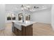 Bright open-concept kitchen, dining, and living area with contemporary fixtures and tile flooring at 20316 W Turney Ave, Buckeye, AZ 85396
