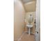 Small powder room with pedestal sink and circular mirror at 20802 N Grayhawk Dr # 1142, Scottsdale, AZ 85255