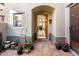 Welcoming entryway with a tiled floor, potted plants, and a view into the living area at 20802 N Grayhawk Dr # 1142, Scottsdale, AZ 85255