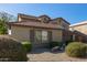 Two-story house with brown garage doors and landscaping at 21391 E Camina Plata --, Queen Creek, AZ 85142