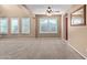 Living room with a red accent wall and large windows at 21391 E Camina Plata --, Queen Creek, AZ 85142