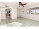 Bright living room featuring tile floors and ceiling fan at 214 W June Cir, Mesa, AZ 85201