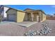 One-story house with a two-car garage and desert landscaping at 2201 N 91St Gln, Phoenix, AZ 85037