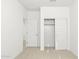 Bright bedroom with neutral walls and carpet, featuring a large closet with sliding doors at 23979 W Cocopah St, Buckeye, AZ 85326