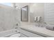 Modern bathroom with marble shower, bathtub, and updated fixtures at 25224 N 159Th Dr, Surprise, AZ 85387