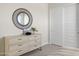 Light bedroom with dresser, mirror, and closet at 25224 N 159Th Dr, Surprise, AZ 85387