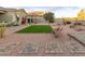 Landscaped backyard with artificial turf and pathways at 3583 N Brooklyn Dr, Buckeye, AZ 85396