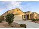 Tan house with a two-car garage and neatly landscaped yard at 3583 N Brooklyn Dr, Buckeye, AZ 85396