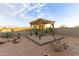Patio with pergola and seating area in backyard at 3583 N Brooklyn Dr, Buckeye, AZ 85396