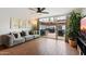 Living room with hardwood floors, large TV, and sliding doors leading to a private patio at 3606 E Osborn Rd, Phoenix, AZ 85018