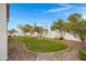 Landscaped backyard with a grassy area, stone border, and walkway at 3620 E Austin Dr, Gilbert, AZ 85296