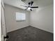 Spacious bedroom with neutral carpeting and ceiling fan at 3738 W Roeser Rd, Phoenix, AZ 85041