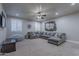 Spacious basement Gathering room with sectional sofa and wall decor at 4135 E Hale Cir, Mesa, AZ 85205