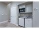 Convenient basement wet bar with microwave and mini-fridge at 4135 E Hale Cir, Mesa, AZ 85205