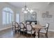 Bright dining room featuring a spacious table, chandelier, and arched window at 4135 E Hale Cir, Mesa, AZ 85205