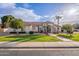 Beautiful one-story home with a manicured lawn and palm trees at 4135 E Hale Cir, Mesa, AZ 85205