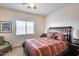 Spacious bedroom with a large bed, window, and additional seating at 44192 W Canyon Creek Dr, Maricopa, AZ 85139