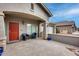 Spacious front porch with red door and two wicker chairs at 44192 W Canyon Creek Dr, Maricopa, AZ 85139