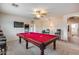 Game room features a pool table, seating, and a large flat-screen TV at 44192 W Canyon Creek Dr, Maricopa, AZ 85139