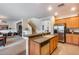 Kitchen island with sink and views into the living room at 44192 W Canyon Creek Dr, Maricopa, AZ 85139