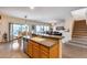 Kitchen island with double sink, open to dining and living areas at 44192 W Canyon Creek Dr, Maricopa, AZ 85139