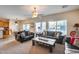 Comfortable living room with leather sofas and large windows at 44192 W Canyon Creek Dr, Maricopa, AZ 85139