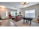 Bright living room with tiled floors, seating area, and a piano at 44192 W Canyon Creek Dr, Maricopa, AZ 85139