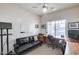 Home office with built-in desk, sofa, and ample natural light at 44192 W Canyon Creek Dr, Maricopa, AZ 85139