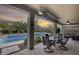Covered patio with pool view, dining area, and seating at 44192 W Canyon Creek Dr, Maricopa, AZ 85139