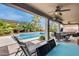 Inviting backyard oasis with a sparkling pool, patio furniture, and lush landscaping at 44192 W Canyon Creek Dr, Maricopa, AZ 85139