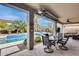 Inviting backyard oasis with a sparkling pool, patio furniture, and lush landscaping at 44192 W Canyon Creek Dr, Maricopa, AZ 85139