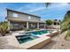 Stunning backyard with a large pool, spa, and expansive patio at 44192 W Canyon Creek Dr, Maricopa, AZ 85139