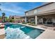 Large inviting pool reflecting the sky, with surrounding patio and landscape at 44192 W Canyon Creek Dr, Maricopa, AZ 85139