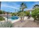Refreshing pool with spacious deck and surrounding landscaping at 44192 W Canyon Creek Dr, Maricopa, AZ 85139