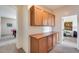 Storage or office space with wooden cabinets and counter at 44192 W Canyon Creek Dr, Maricopa, AZ 85139