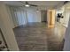 Spacious living room with mirrored walls and wood-look floors at 4444 E Paradise Village Pkwy # 159, Phoenix, AZ 85032