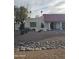 View of the front yard with desert landscaping, privacy gate, and red-tiled roof at 49 W Secretariat Dr, Tempe, AZ 85284