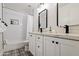 Modern bathroom with double vanity, white cabinets, and patterned floor at 5112 N 35Th St, Phoenix, AZ 85018
