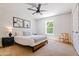 Bright bedroom with a queen bed, wood nightstand and window at 5112 N 35Th St, Phoenix, AZ 85018