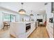 Modern kitchen with marble island, stainless steel appliances, and light wood floors at 5112 N 35Th St, Phoenix, AZ 85018