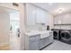 Bright laundry room with modern washer, dryer, and farmhouse sink at 5112 N 35Th St, Phoenix, AZ 85018