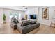 Open living area featuring a gray sectional sofa and large TV at 5112 N 35Th St, Phoenix, AZ 85018